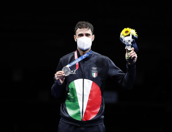 epa09362282 Silver medalist Luigi Samele of Italy celebrates on the podium during a victory ceremony of the men's Sabre individual event during the Fencing events of the Tokyo 2020 Olympic Games at the Makuhari Messe convention centre in Chiba, Japan, 24 
