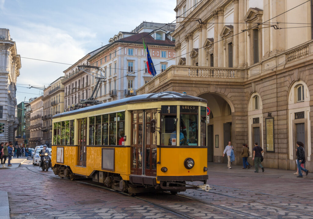 Old tram passing at La Scala theatre in Milan